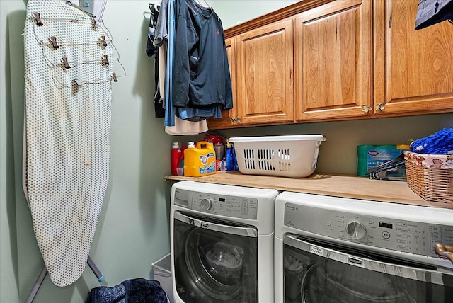 laundry room with cabinets and washer and clothes dryer