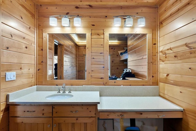 bathroom with vanity and wood walls