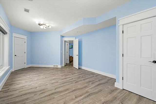 empty room with light hardwood / wood-style floors