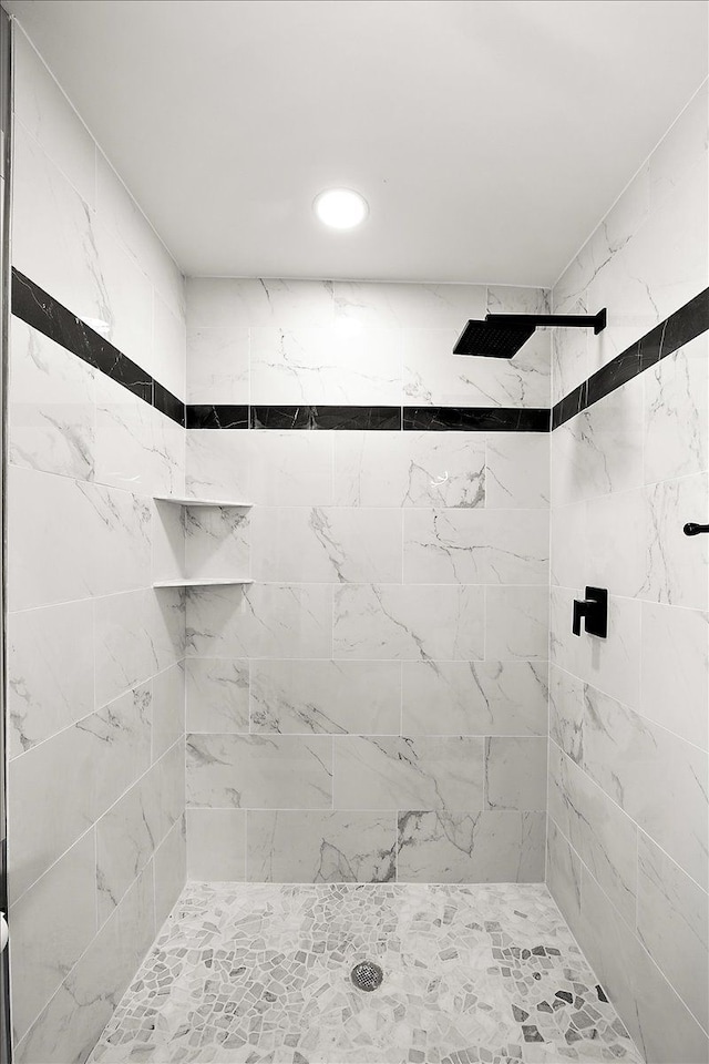 bathroom with a tile shower