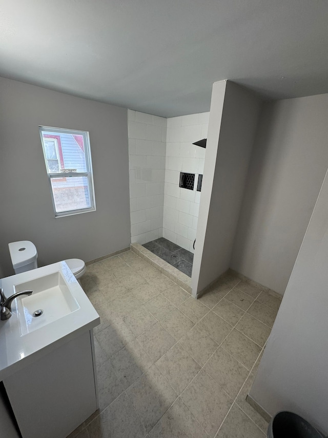 bathroom featuring vanity, toilet, and a shower