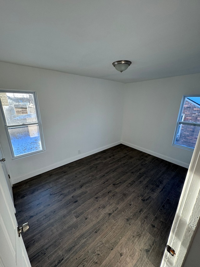 empty room featuring dark hardwood / wood-style flooring