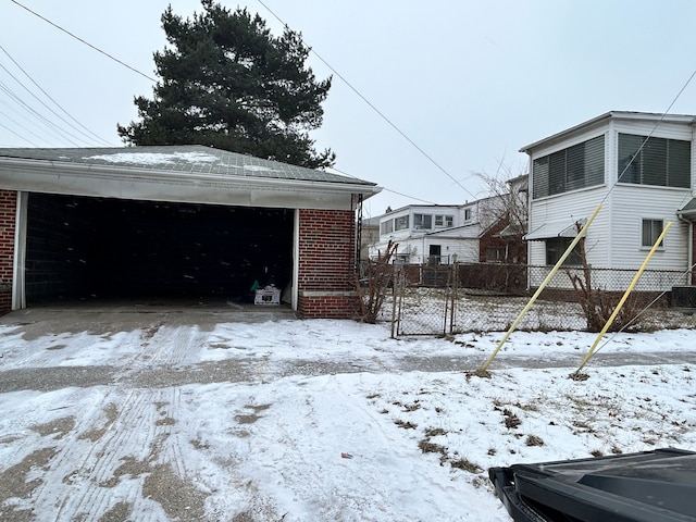 yard layered in snow featuring a garage