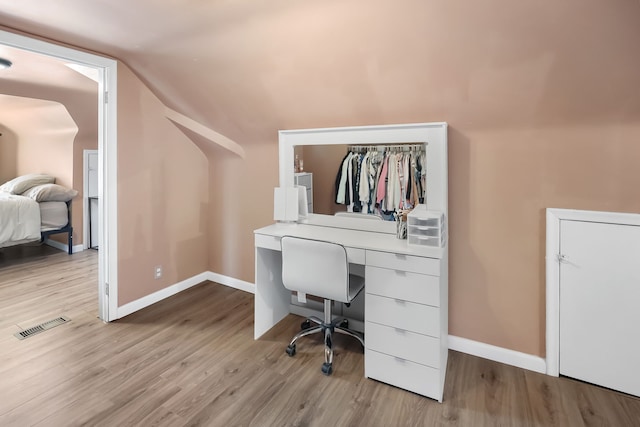 office featuring lofted ceiling and light wood-type flooring