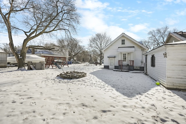 snowy yard featuring an outdoor fire pit