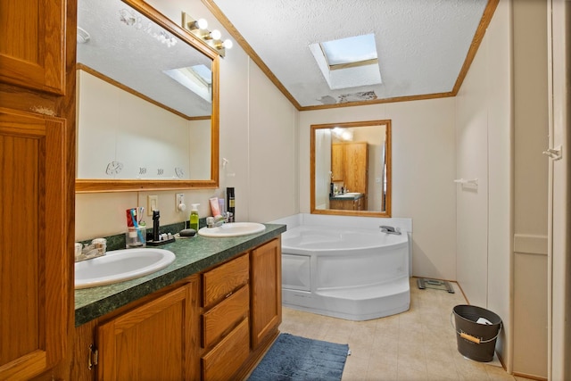 bathroom with ornamental molding, vanity, a textured ceiling, and a washtub