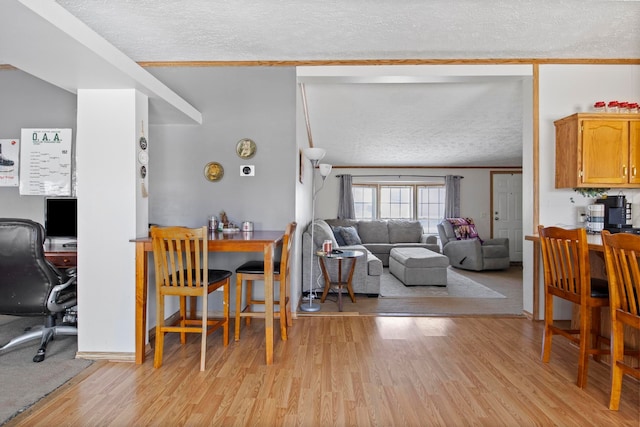 living room featuring a textured ceiling and light wood-type flooring