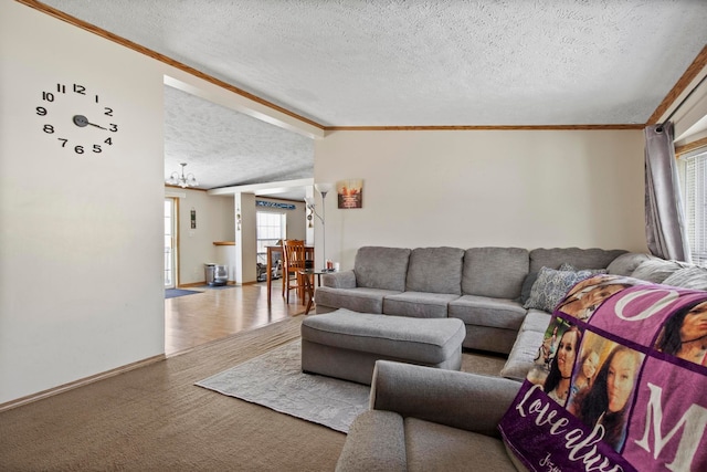 living room with ornamental molding, light carpet, and a textured ceiling