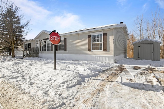 view of front of house with a storage shed