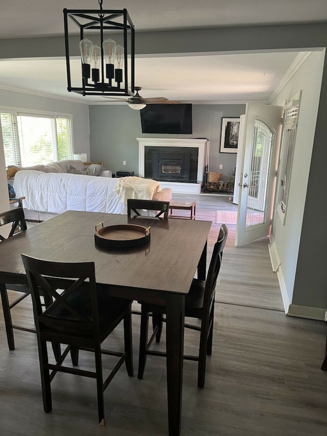 dining room with crown molding and wood-type flooring