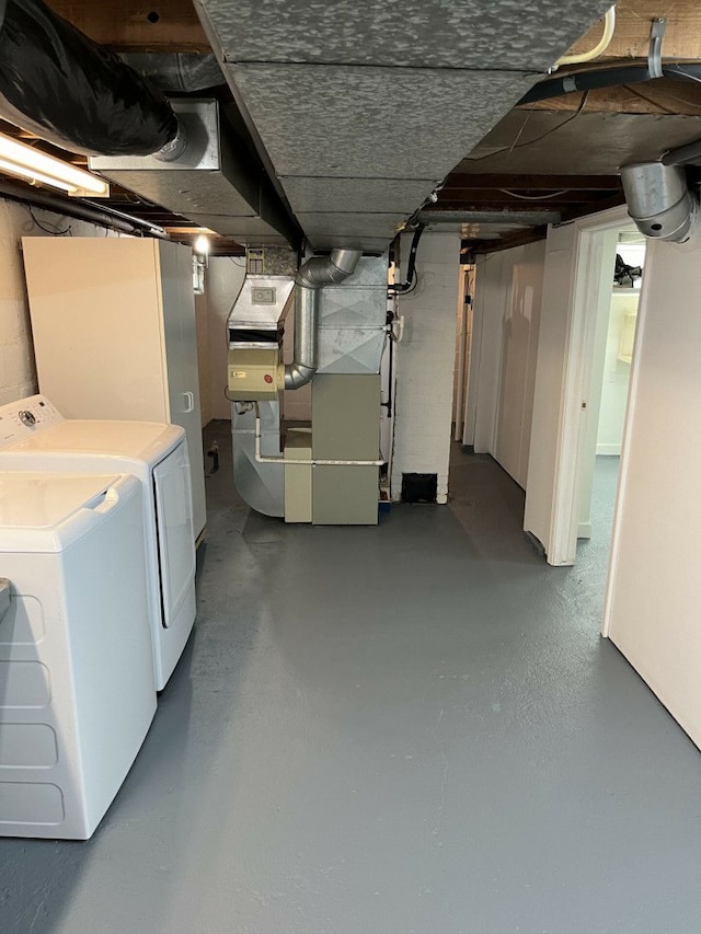 basement with heating unit and washer and dryer