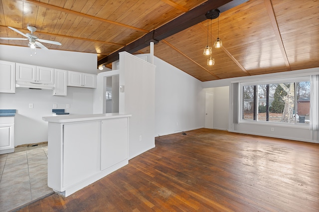 kitchen with hardwood / wood-style floors, lofted ceiling with beams, white cabinets, hanging light fixtures, and ceiling fan