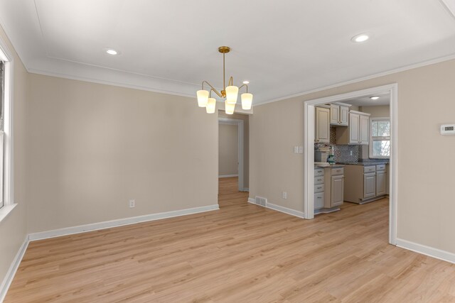 interior space featuring an inviting chandelier, crown molding, and light hardwood / wood-style flooring