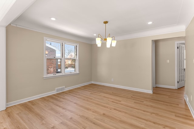 unfurnished room featuring a notable chandelier, crown molding, and light hardwood / wood-style floors