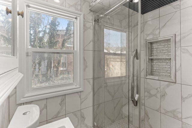 bathroom featuring a shower with door