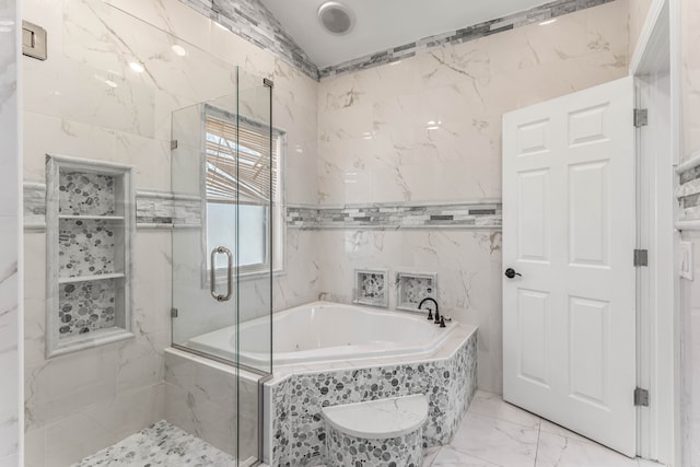 bathroom featuring lofted ceiling, plus walk in shower, and tile walls