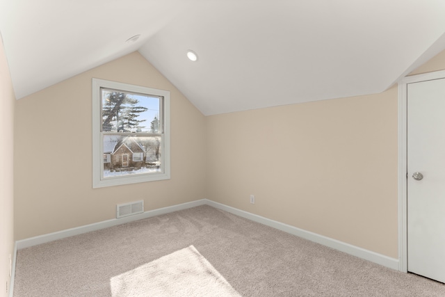 bonus room featuring light colored carpet and vaulted ceiling