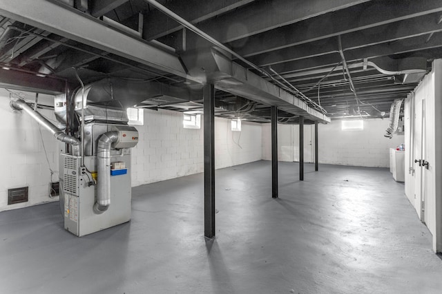 basement featuring washer / clothes dryer and heating unit