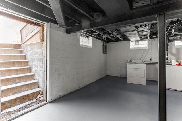 basement with plenty of natural light, washer / dryer, and electric panel