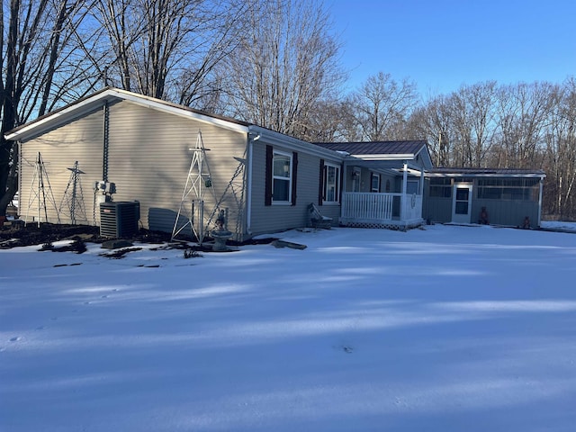 exterior space with central AC unit and covered porch