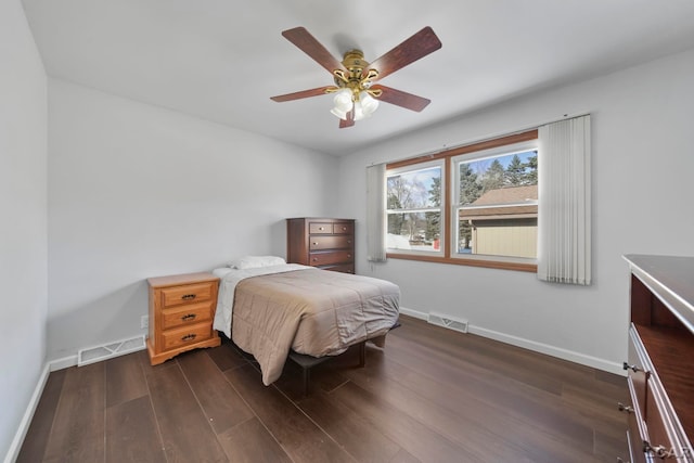 bedroom with dark hardwood / wood-style floors and ceiling fan