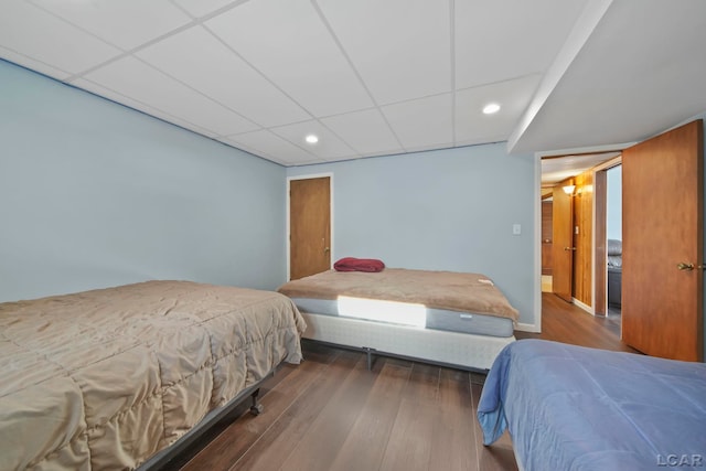 bedroom with hardwood / wood-style floors and a drop ceiling