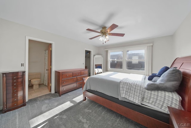 carpeted bedroom with ceiling fan and ensuite bathroom