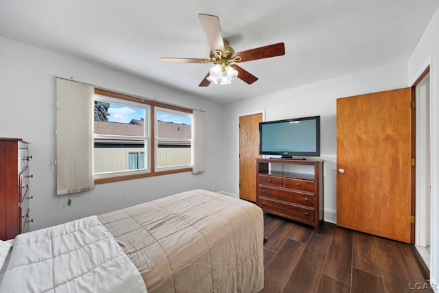 bedroom with dark hardwood / wood-style floors and ceiling fan