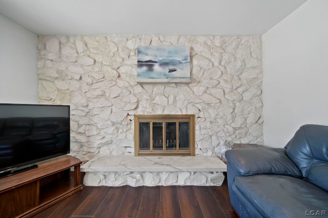 living room with hardwood / wood-style flooring and a fireplace