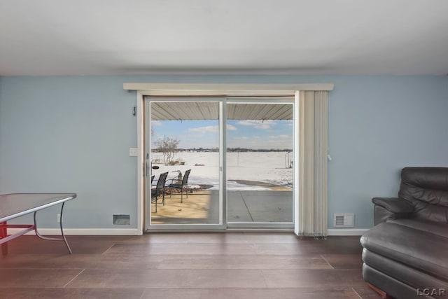 doorway to outside featuring hardwood / wood-style floors and a water view