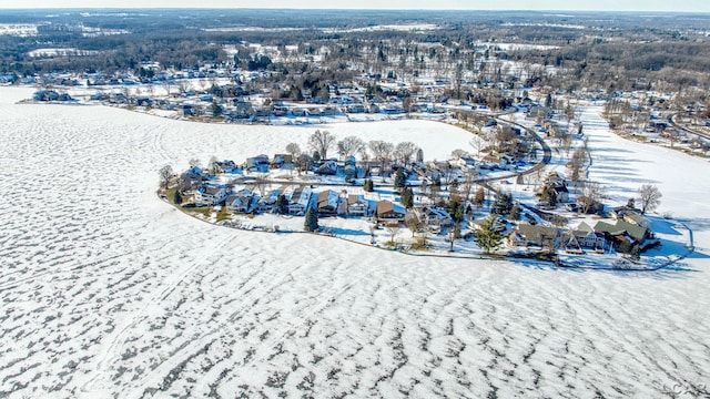 snowy aerial view with a water view