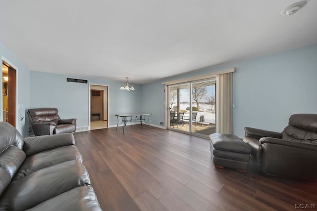 living room with an inviting chandelier and hardwood / wood-style floors