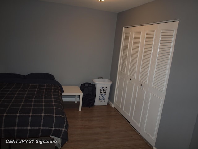 bedroom with hardwood / wood-style flooring and a closet