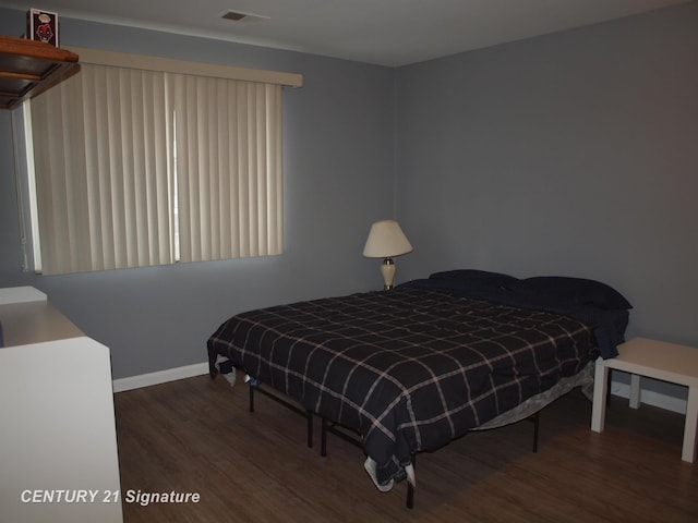 bedroom featuring dark wood-type flooring