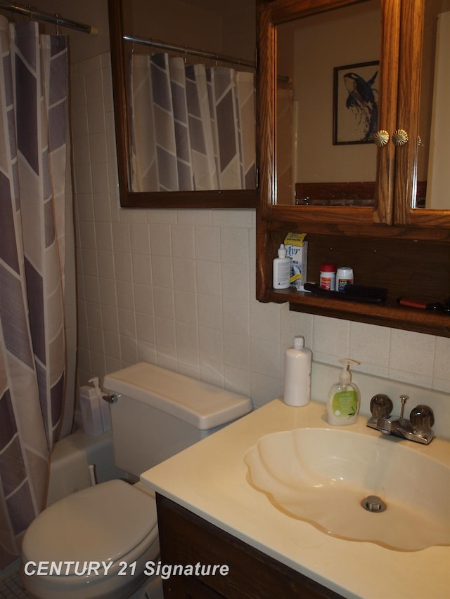 bathroom featuring tasteful backsplash, vanity, tile walls, and toilet