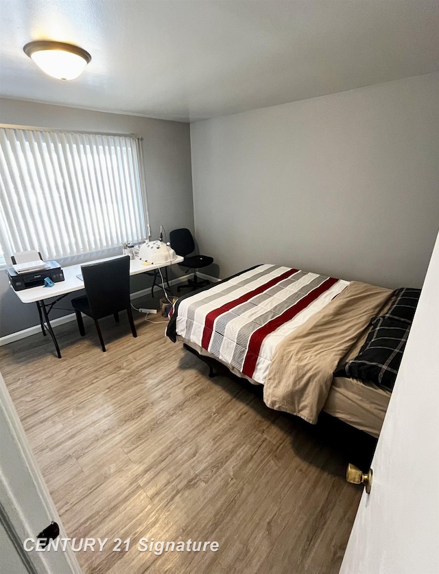 bedroom with wood-type flooring