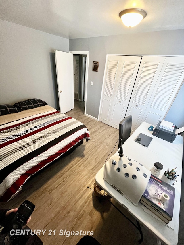 bedroom featuring light hardwood / wood-style floors and a closet