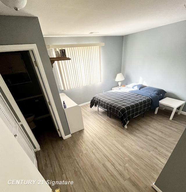 bedroom with hardwood / wood-style flooring and a closet