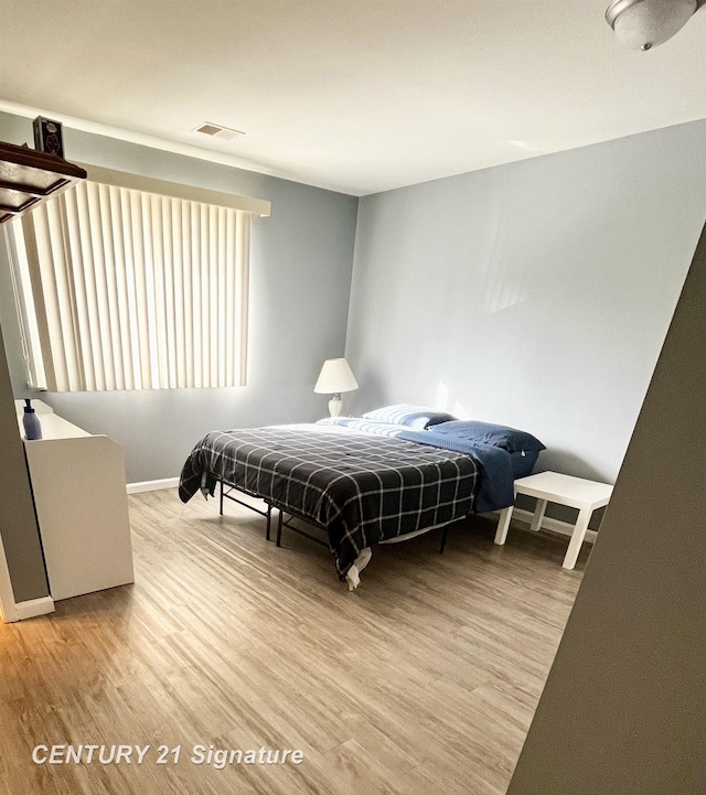 bedroom featuring hardwood / wood-style flooring