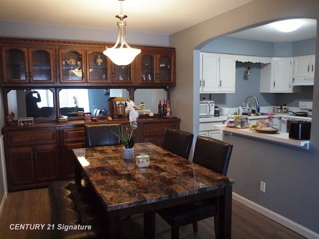 dining area featuring dark hardwood / wood-style flooring