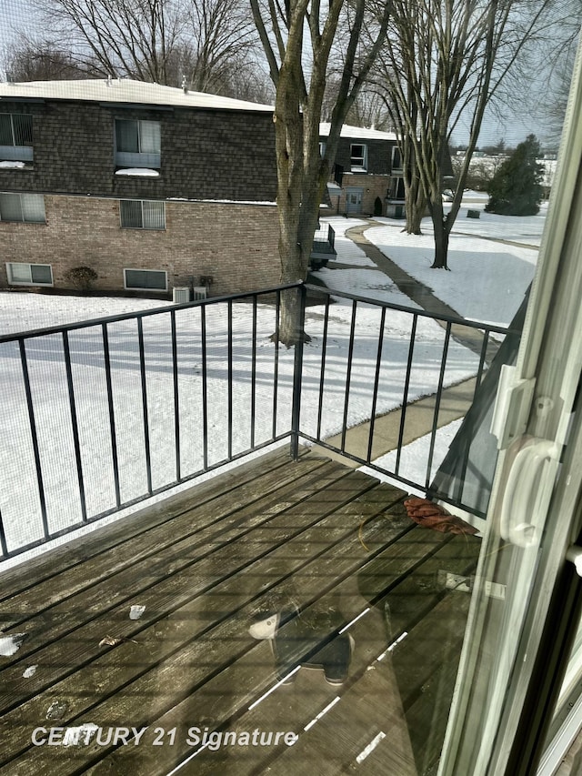 view of snow covered back of property