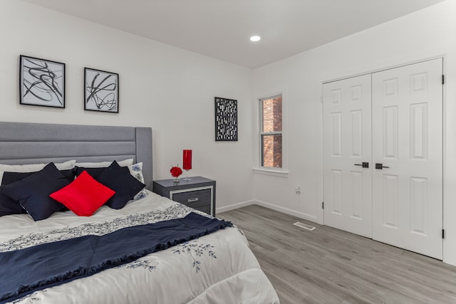 bedroom featuring light hardwood / wood-style floors and a closet