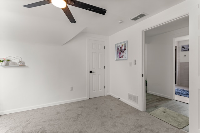 bonus room featuring vaulted ceiling, light carpet, and ceiling fan