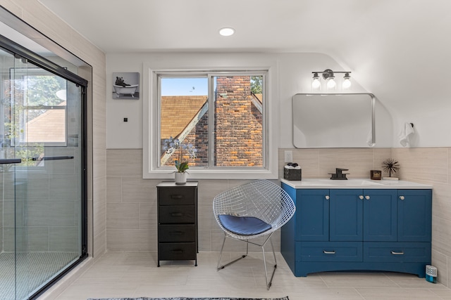 bathroom with vanity, a shower with shower door, and vaulted ceiling