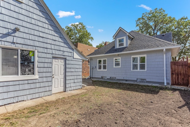 rear view of property with a lawn