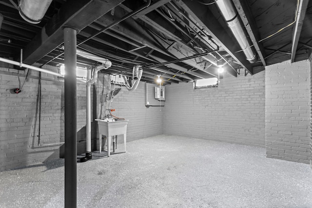 basement with sink and electric panel