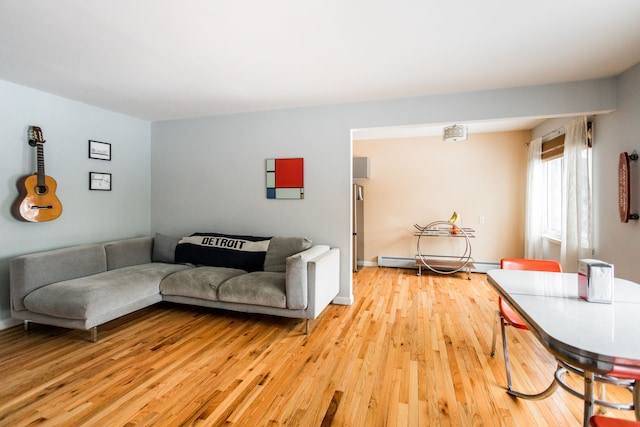 living room with baseboard heating and light wood-type flooring