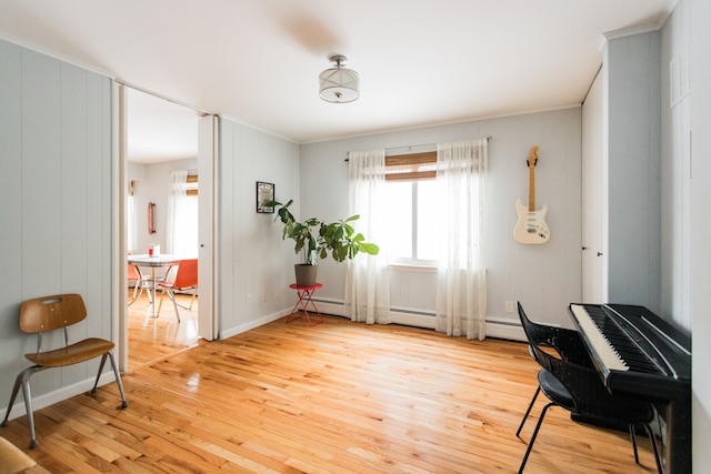 sitting room with light hardwood / wood-style flooring and wood walls