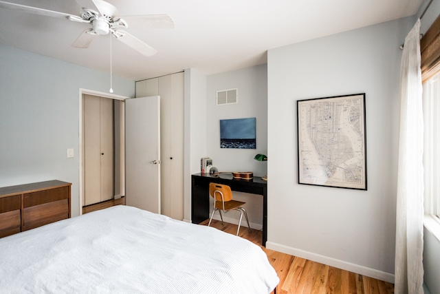 bedroom with a closet, ceiling fan, and light wood-type flooring