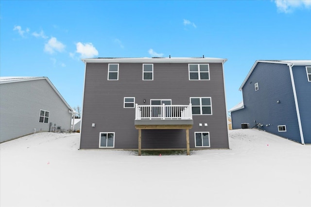 view of snow covered back of property